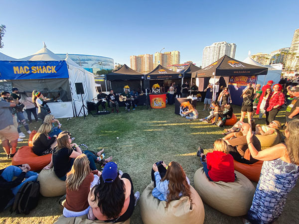 Crowd gathered around Koi CBD tent at Cali Vibes